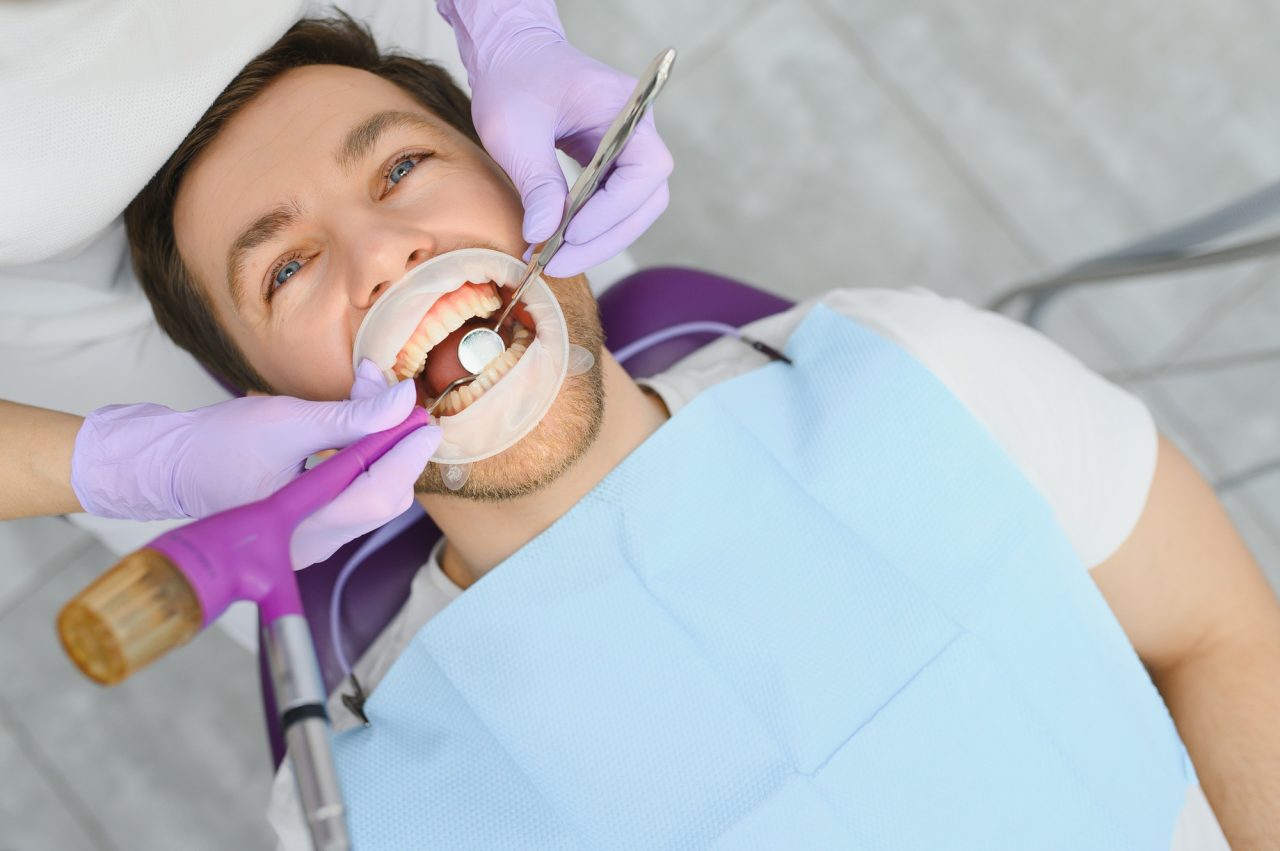 Centro Recanto das Garças 13 periodontal services closeup shot of smiling man getting treatment in stomatologic clinic 1