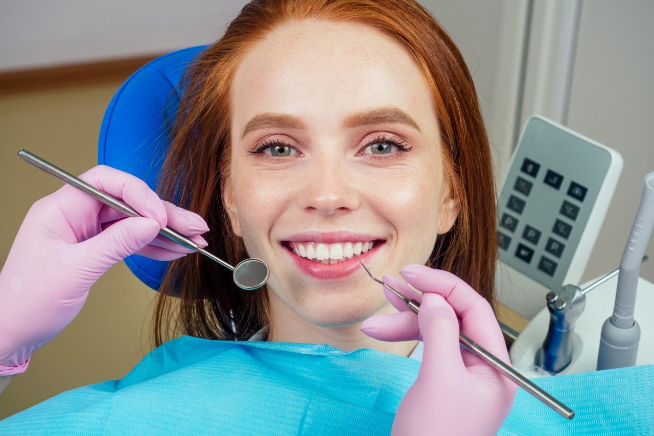 Centro Recanto das Garças 9 portrait of an attractive smiling redhaired ginger customer girl in a dental chair